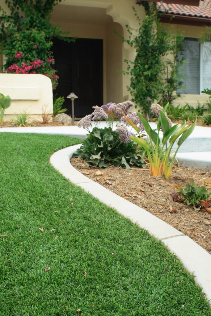 The perfect irrigation system for your home's lawn can keep it looking as lush as the lawn pictured here.